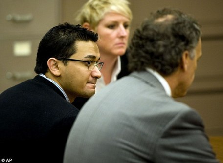 Guilty: Mr Murtaza, left, listens to the verdicts between defense attorneys Julie Swain, center, and Doug Myers, right 