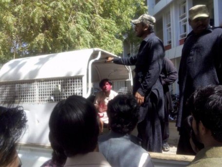 Campus security guards detain a student who had been celebrating Holi and had allegedly been involved in a ruckus. PHOTO: FACEBOOK/FAYAZ ALI
