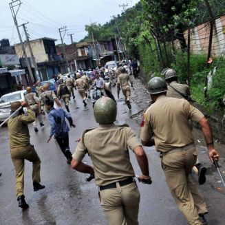 Muslim Fundamentals clashed with Police as usual. Police chase away protesters during clash in Rajouri on Tuesday. Pic. PTI