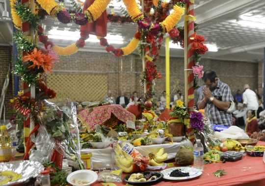 A Hindu man prays at the goddess stage set up for the Puran celebration in Burlington on Sunday. (Photo: ELIZABETH MURRAY/FREE PRESS)