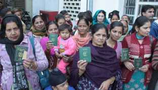 Members of Hindu families who migrated from Pakistan show their Pakistani passports in Jalandhar. They question if citizenship can be granted to Pakistani singer Adnan Sami, why not them. Tribune Photo: Malkiat Singh