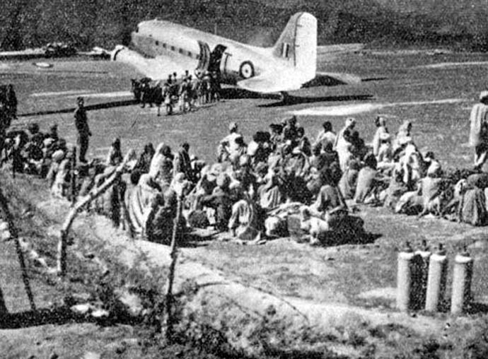 Refugees awaiting evaciation by IAF Dakota in Poonch airstrip, 1947. [Photo: Wikimedia]