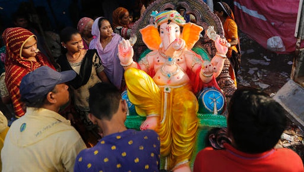 Indians carry an idol of elephant headed Hindu god Ganesha on the eve of Ganesh Chaturthi festival in Ahmadabad, India, Sunday, Sept. 4, 2016. The idol will be immersed in water bodies after worship at the end of the festival. (Photo|AP)